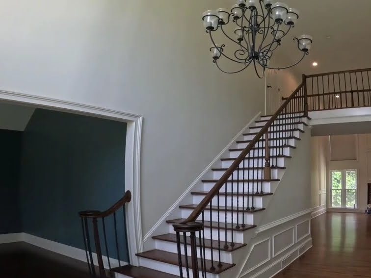 New hardwood matched to the existing floor, with finished stairs and handrails, in an Alpharetta, GA home