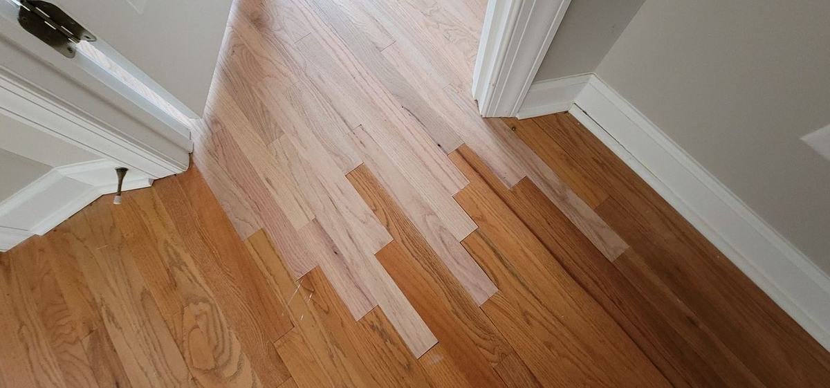 Hardwood floor patch and lacing repair completed by The Hardwood Guys