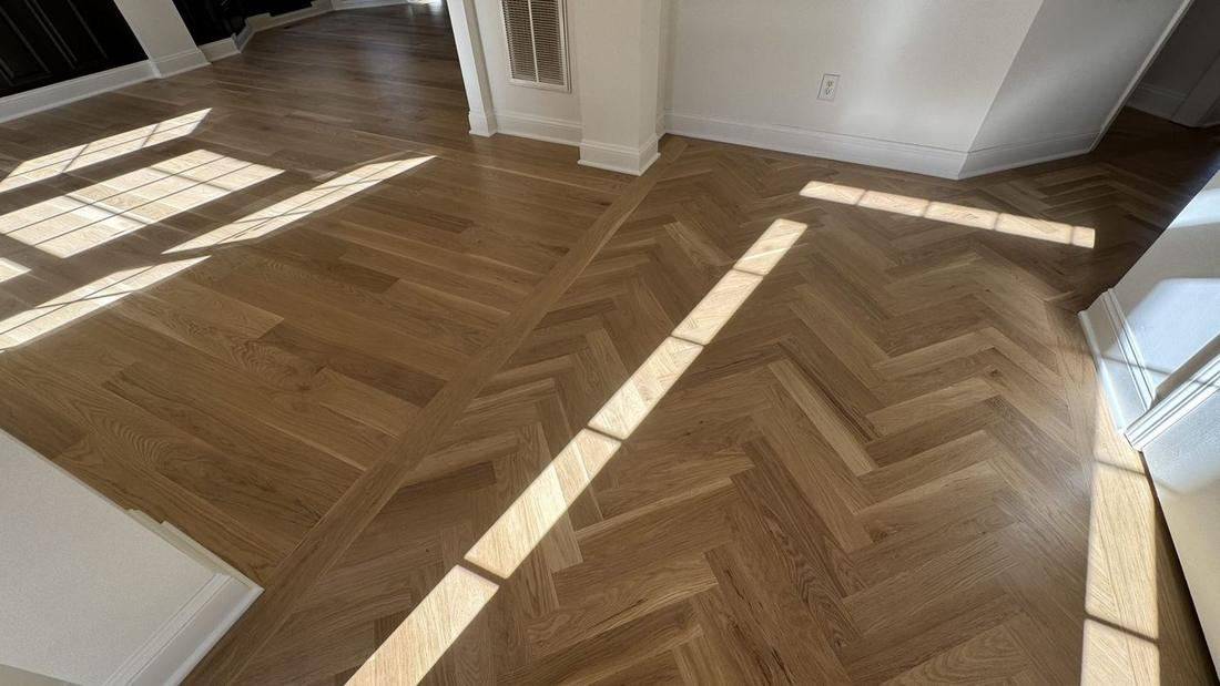 Herringbone-pattern white oak hardwood flooring installed by The Hardwood Guys in a Metro Atlanta home