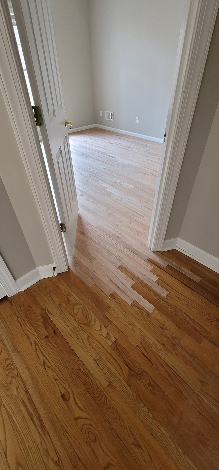 Hardwood floor threshold and corner repair completed by The Hardwood Guys
