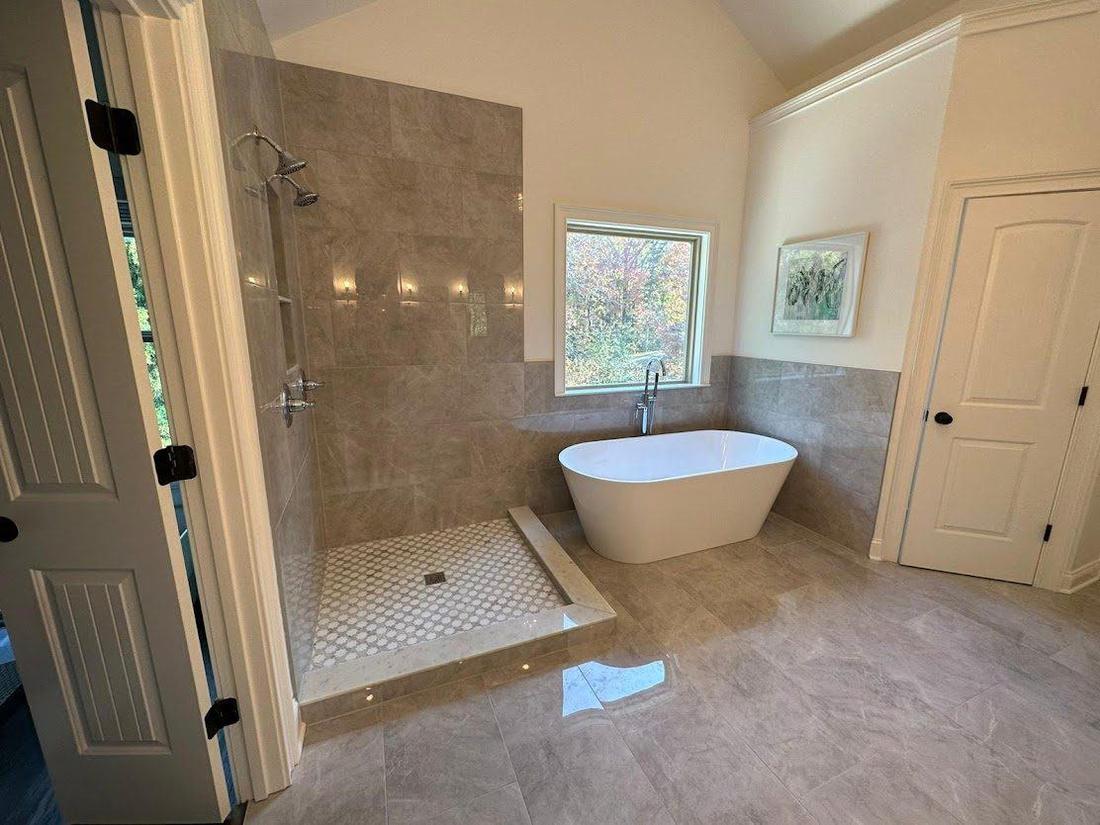 Bathroom remodel with a freestanding soaking tub and tile surround
