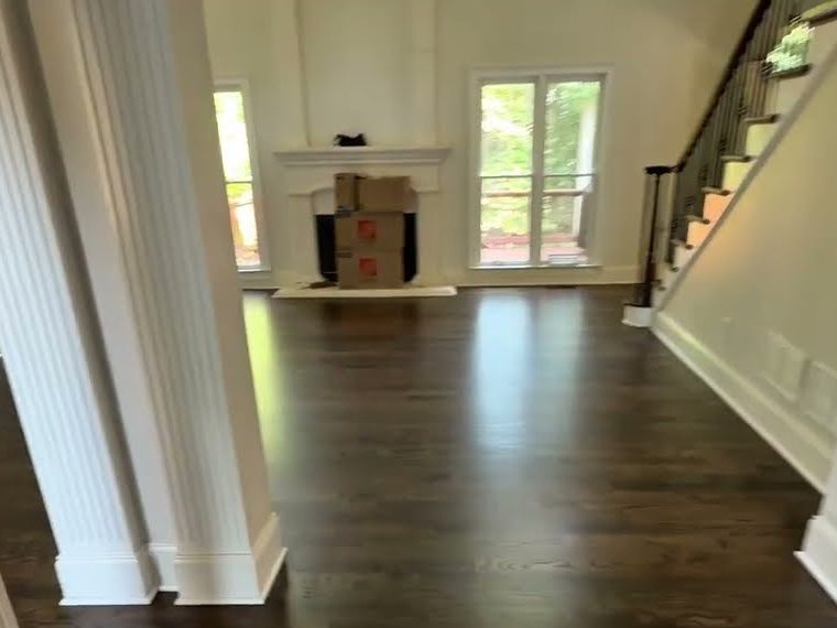 Dark Walnut stained hardwood floor in a living area with a staircase, refinishing in Canton, GA