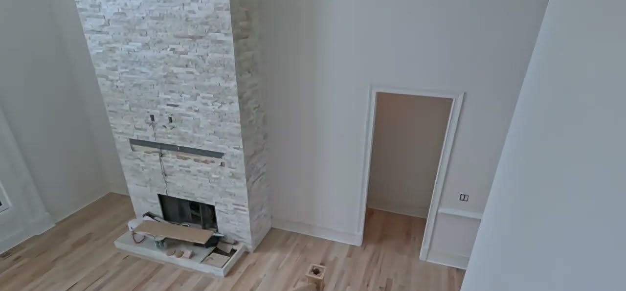 East Cobb red oak floor beside a stone fireplace after Bona Red Out, Natural Seal and Bona Traffic HD
