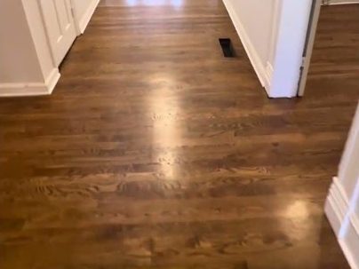 Glossy Early American stained hardwood floor in a hallway, refinishing in Marietta, GA