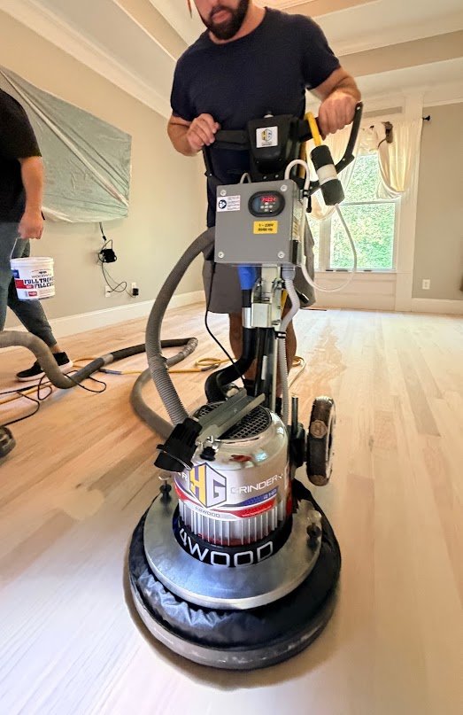 The Hardwood Guys crew running a professional floor machine on a hardwood job site in North Georgia