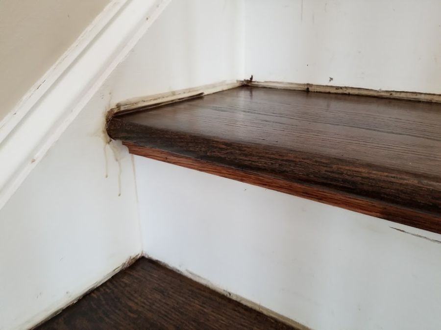 Stain marks along the tread perimeter and skirt board — a painter makes these perfect again.
