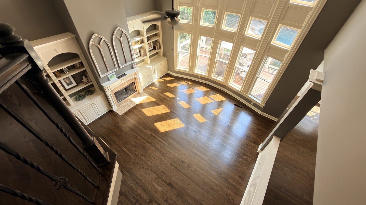 Red oak floors refinished with a dark walnut stain in a two-story Marietta, GA great room