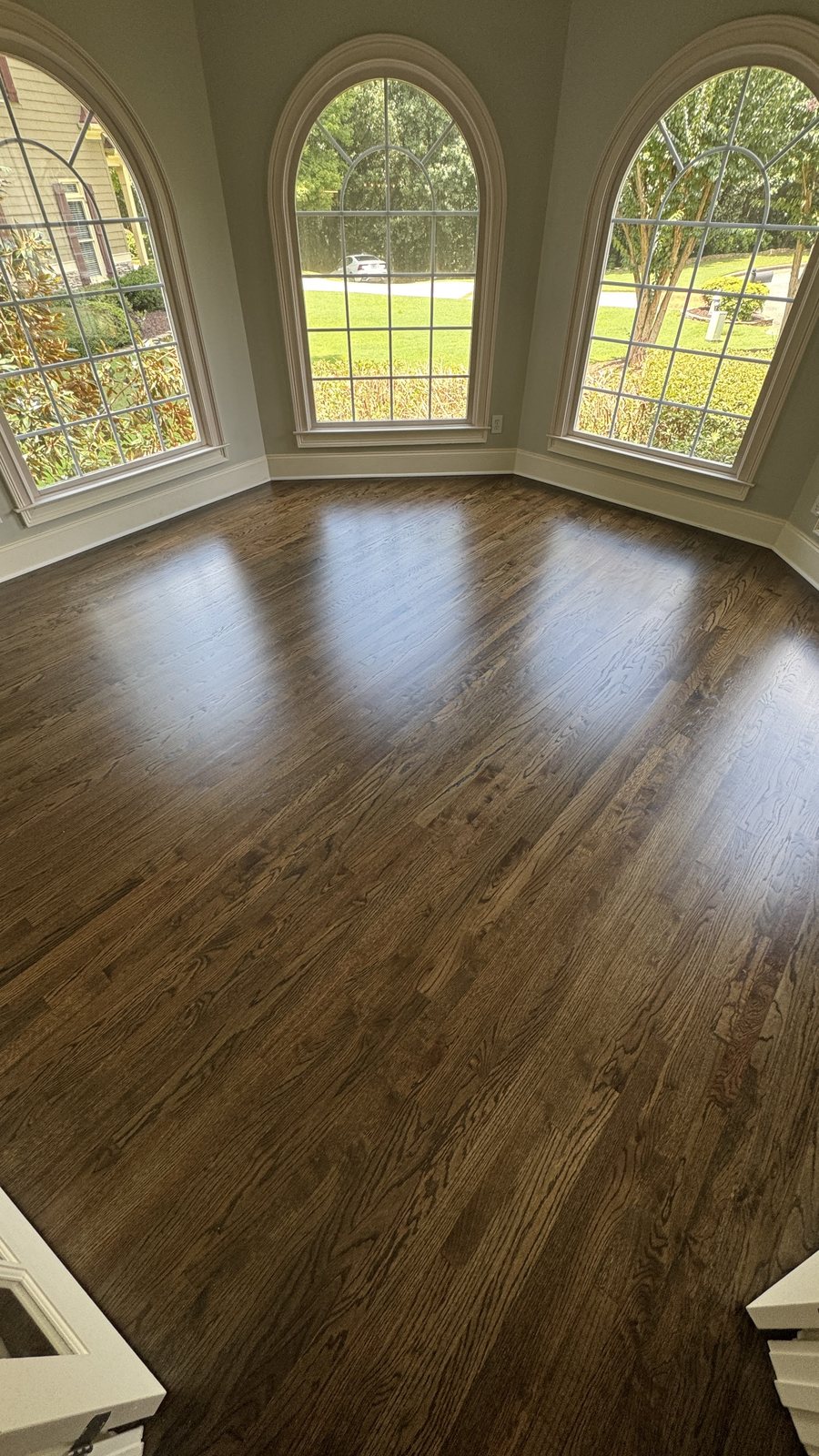 Sunroom with red oak hardwood floor in Dark Walnut stain and matte finish, three arched windows