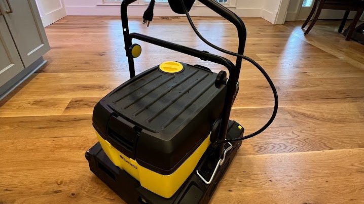 Tornado floor machine used for screen-and-recoat and deep cleaning on a red oak floor