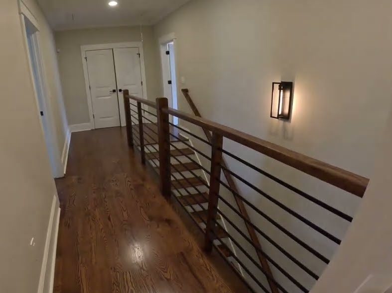 Upstairs hallway with a stained red oak floor and railing, Provincial stain refinishing in Woodstock, GA